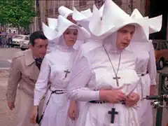 Ritter hides behind a crowd of nuns in white wimples and robes as he escapes