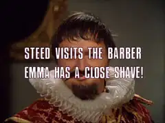 subtitle card: white all caps text with black dropshadow to the left reading ‘STEED VISITS THE BARBER
			EMMA HAS A CLOSE SHAVE!’superimposed on the close-up of Thyssen in Elizabethan dress, Thyssen is now smiling