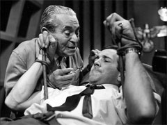 publicity still: Dr. Keuzer threatens a restrained Dr. Keel with the hypodermic needle that will send him to sleep